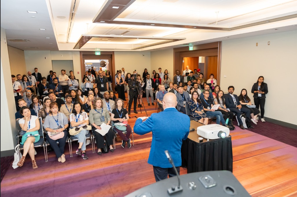 Speaker leading a workshop for a full room of attendees